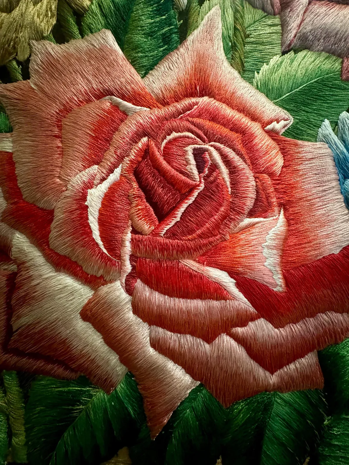 A rose worked in raised silk