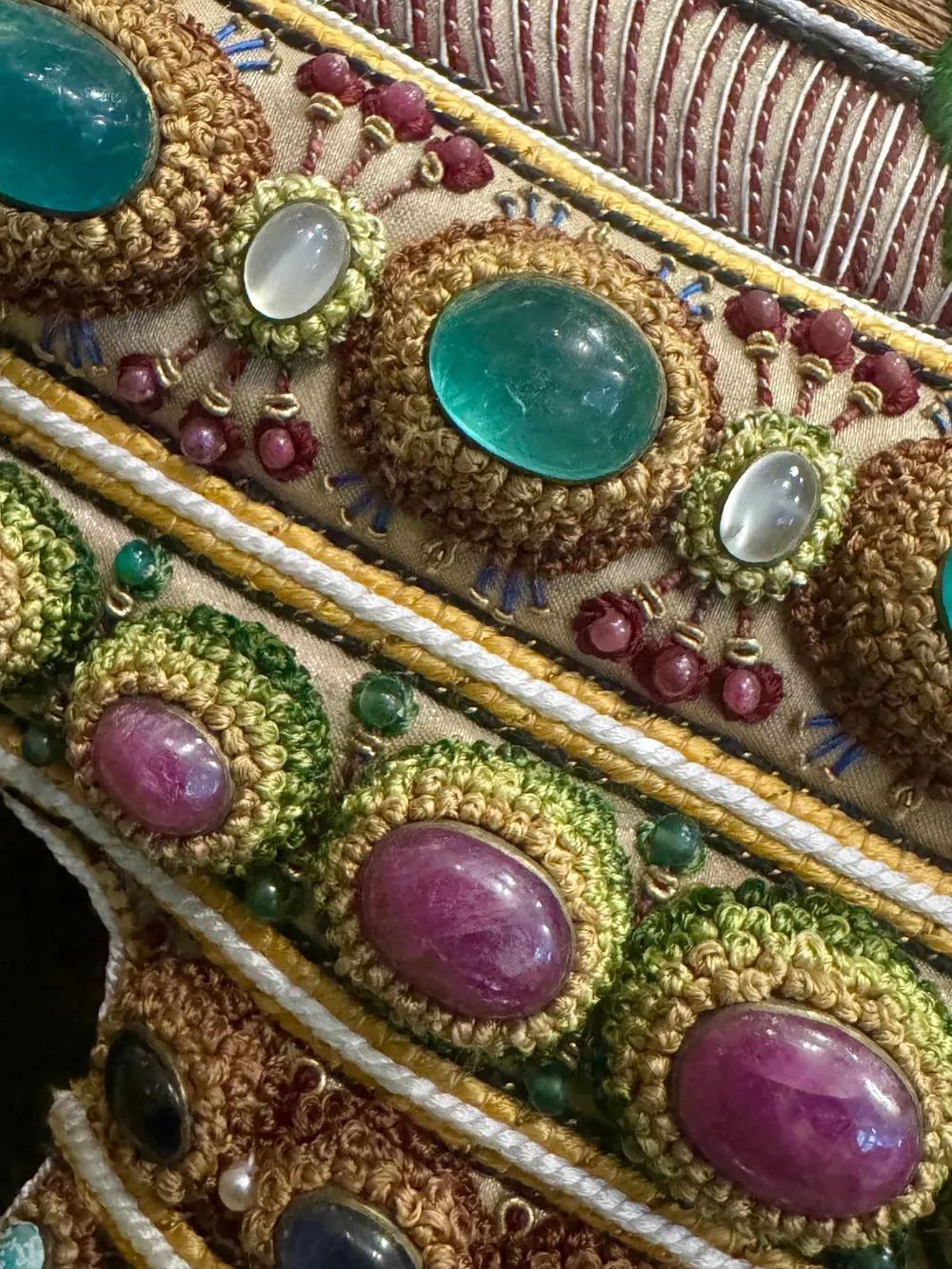 A curved band of the vessel set with coloured stones