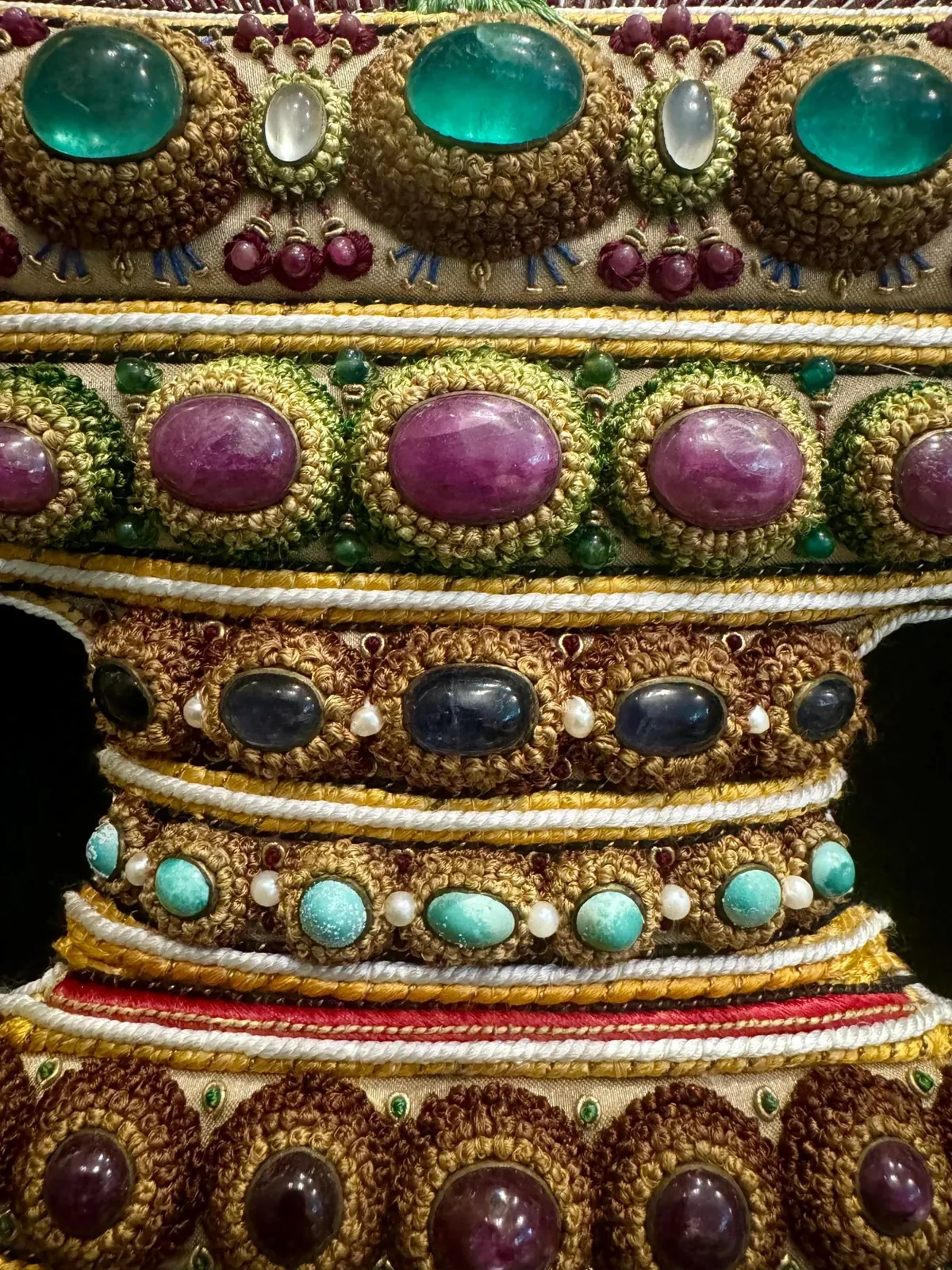 Tiers of embroidered bands on the vessel