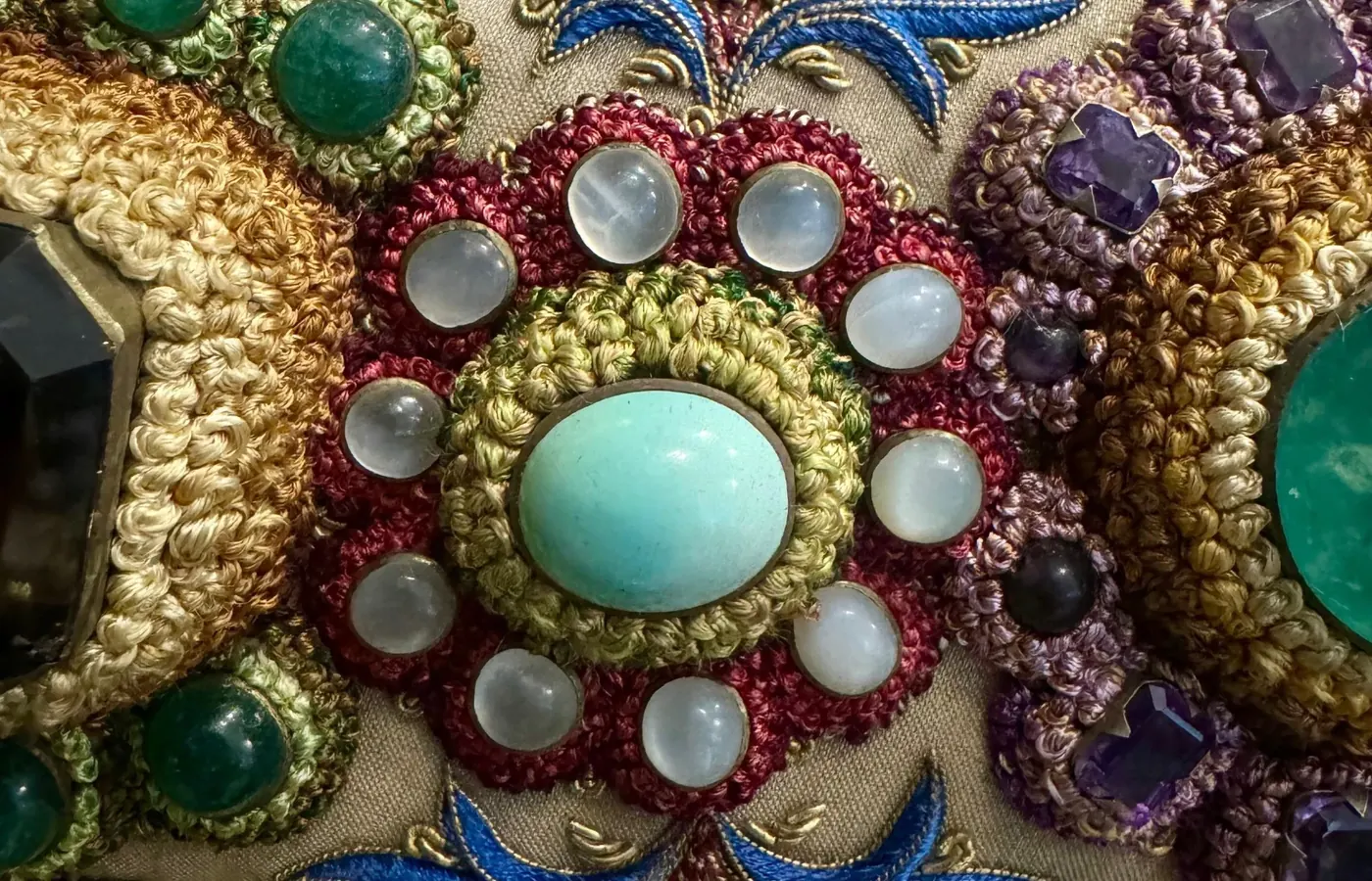 A turquoise rosette ringed with pearls